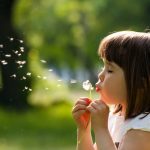 Pollen - girl blowing dandelion
