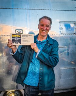 Our founder holding our award