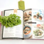 Open cook book with ingredients nearby