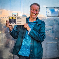 Our founder holding the BOOM award