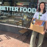 team member outside the shop with a box of ingredients donation